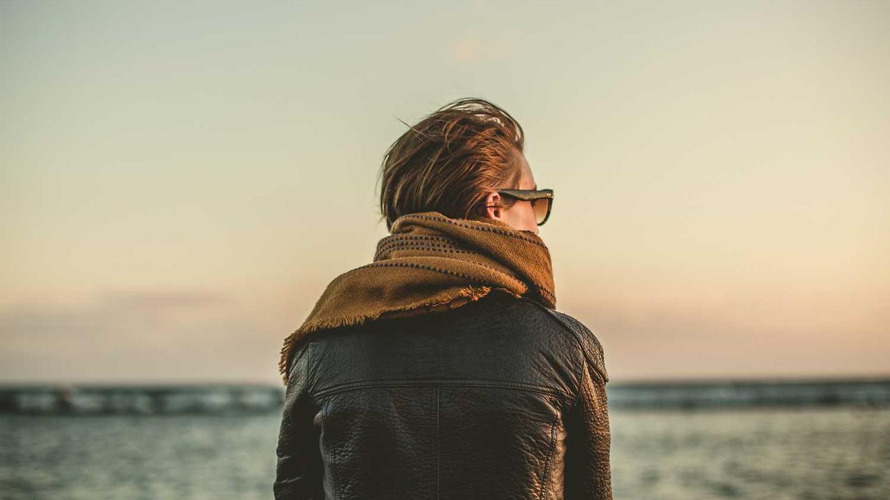 potrait of a person with sunglasses, scarf and jacket